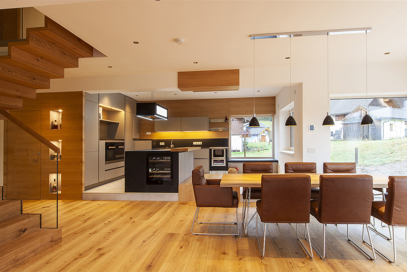 Moderne Küche in Schlammgrau mit Holz und großem Esstisch