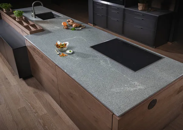Moderne Kücheninsel mit grauer Steinarbeitsplatte, Induktionskochfeld und Spüle
