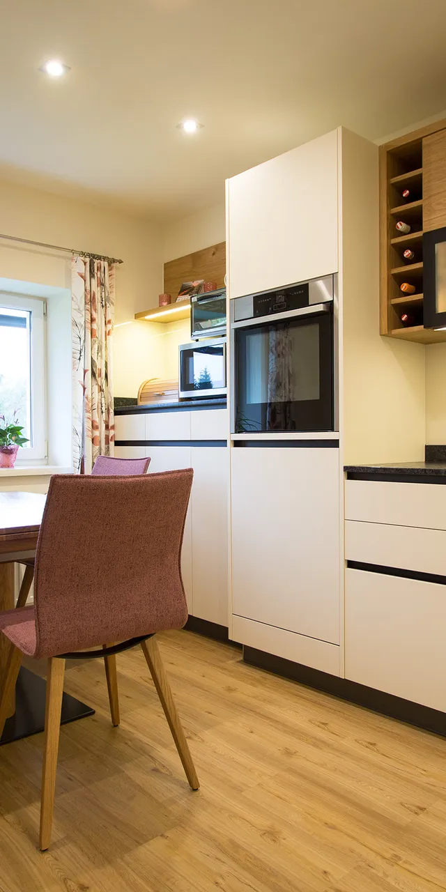 Moderne Einbauküche mit Essbereich, Holzfußboden und pastellfarbenen Möbeln