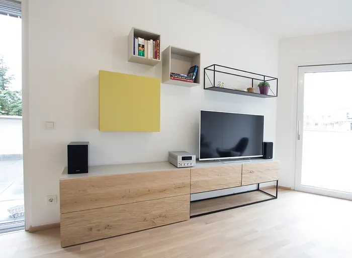Modernes Wohnzimmer mit TV, Holzkommode, Wandregalen und minimalistischer Einrichtung