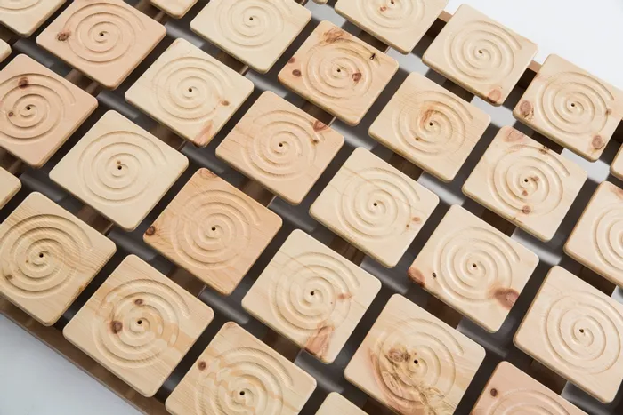Holzlattenrost mit quadratischen, spiralförmig geschnitzten Elementen aus Naturholz